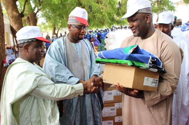 Governor Aminu Waziri Tambuwal assisted by the Sokoto Commissioner of Health Dr