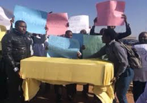 doctors protest with mock coffin